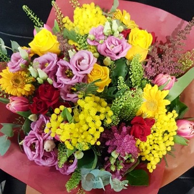 Vibrant, full of sunshine bouquet to include Mimosa, roses, grasses, daisies, ranunculus.  Handmade by local florist in Bromley, Kent