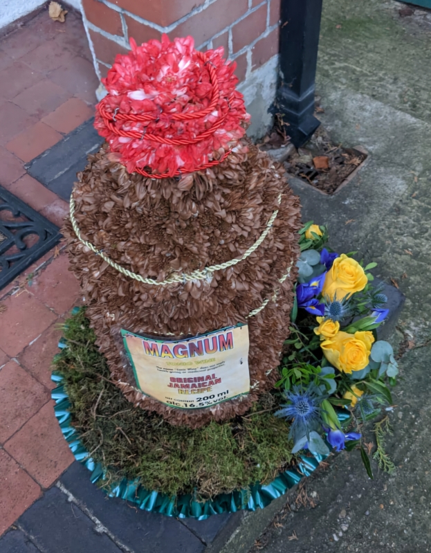 3 d beer bottle funeral flowers by Blooms and Candy florist