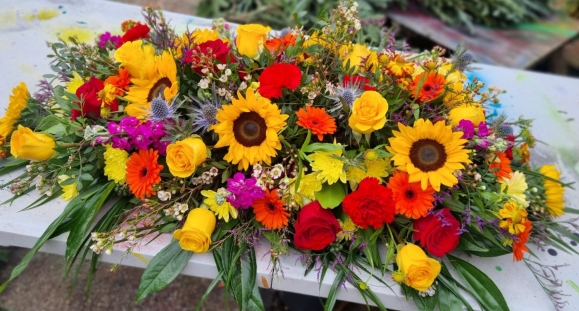 Bright coffin spray for a farewell made by florist in Hayes, Bromley, UK