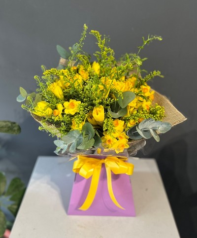 Spring finally is here with this bright striking bouquet made of Daffodils and Narcissus dressed with spring lime foliage and solidago. Made by florist in Bromley 