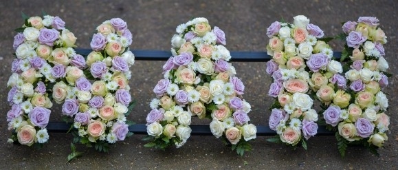 Gorgeous letters based in spray roses in cream, peach and lilac with no greenery. Designed by florist in Hayes, Kent, UK