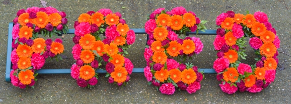 Neon Orange and Hot Pink Mixed Funeral Letters perfect for Indian or Hindu funeral but also for those who loved bright colours made by florist in Bromley, Kent, UK