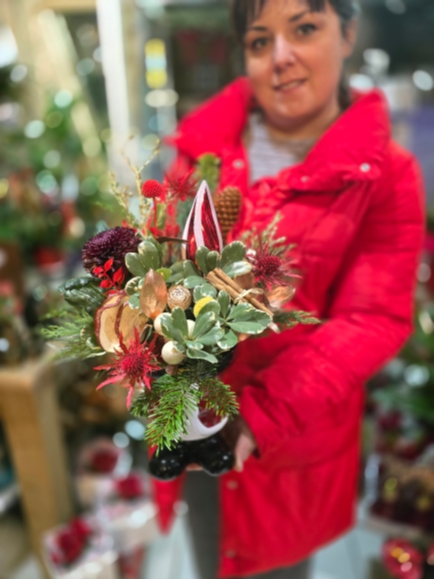 Cheerful Santa's Boot pot wit Christmas flowers and foliages made by florist in Bromley 