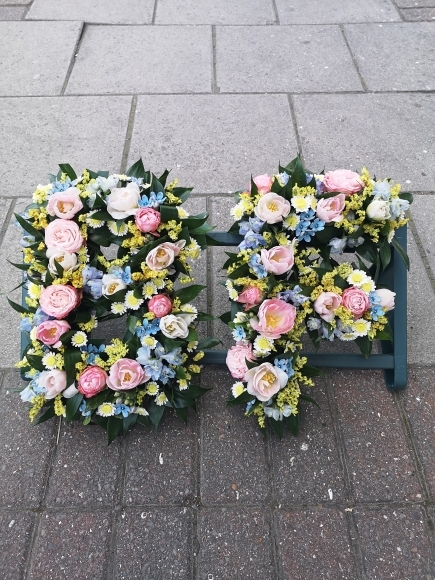 pastel mixed flowers to include light pink, light blue, creams and yellows made by funeral florist in Bromley, Beckenham, Croydon, South London