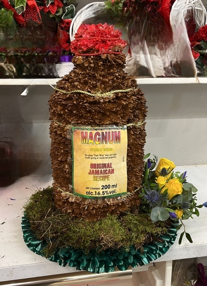 3 d beer bottle funeral flowers by Blooms and Candy florist