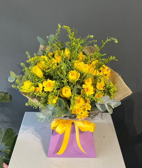 Spring finally is here with this bright striking bouquet made of Daffodils and Narcissus dressed with spring lime foliage and solidago. Made by florist in Bromley 