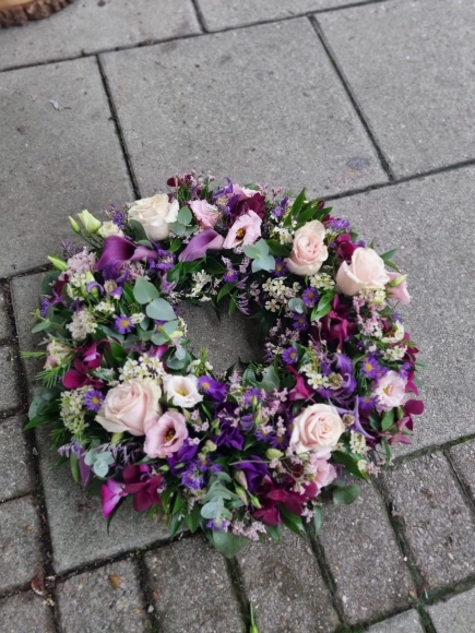 Stunning soft pinks, lilacs and purples funeral wreath to bring back Fondest Memories by florist in Bromley 