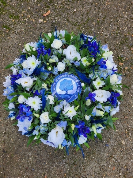 Funeral wreath with flowers with lrinted Logo inside made by florist in Bromley 