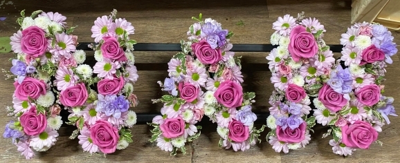 mixed pinks funeral letters from Rowland Brothers and Co Op Funerlcare brochure made by florist in Bromley