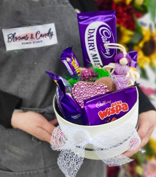 Hat box with Cadbury products with indoor planter in ceramic pot made by florist in Bromley