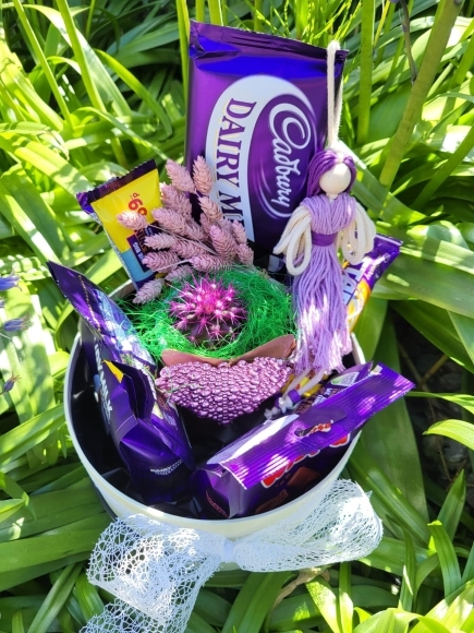 Hat box with Cadbury products with indoor planter in ceramic pot made by florist in Bromley