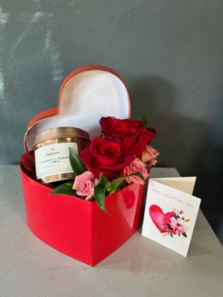 Cute heart shaped hatbox with our own collection of Day Dreamer Strawberry and Rhubarb candle accompanied with 3 red roses and spray rose. Free mini Valentine's card included. By florist in Hayes, Bromley, Kent