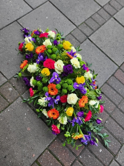 Vibrant classic coffin spray made by florist from Hayes in Bromley 