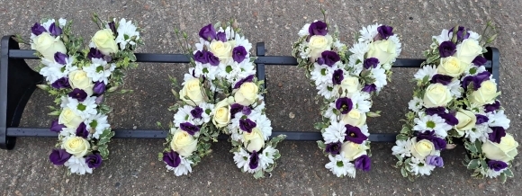 Mixed white and purple funeral wording made by florist in Bromley for free delivery in Bromley, Croydon, Beckenham, Petts Wood, Orpington, Biggin Hill